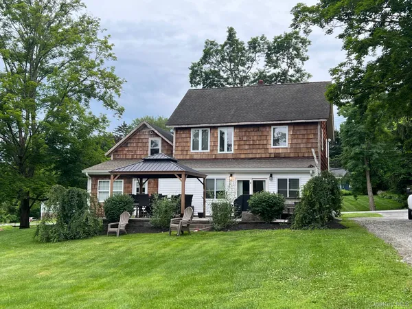 a front view of a house with a garden