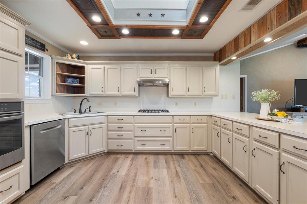 3057 Holy Road Abbott, TX 76621 - Photo 12 of 39 a kitchen with granite countertop white cabinets and white appliances