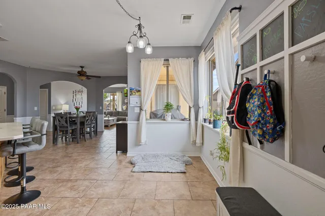 a lobby with furniture and a potted plant