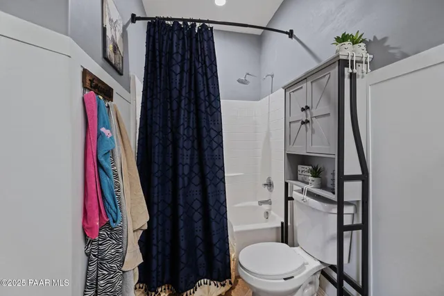 a bathroom with a shower toilet and sink