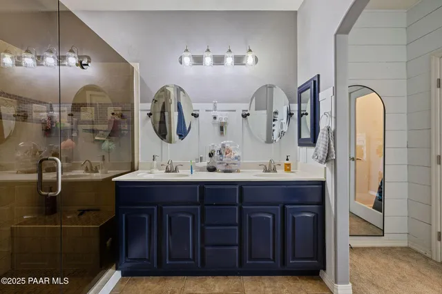 a bathroom with a double vanity sink and a mirror
