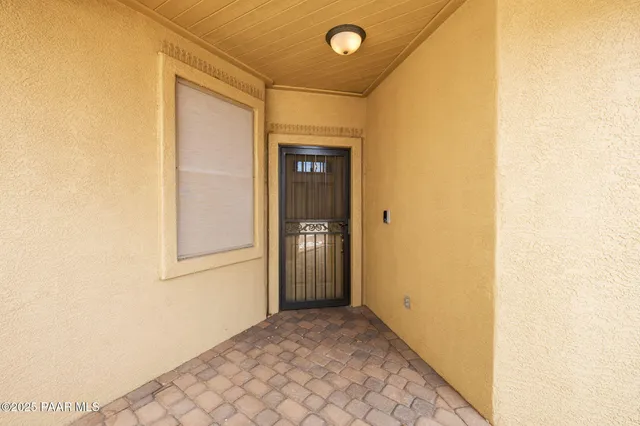 a view of a hallway with wooden shelves