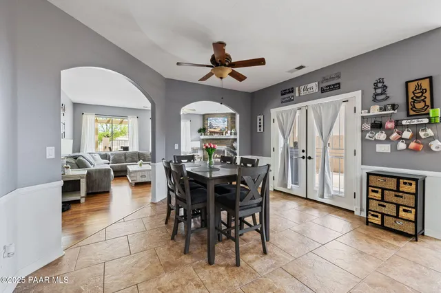 a view of a dining room with furniture and a chandelier fan