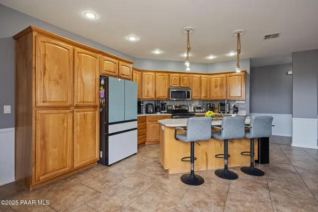 a kitchen with a refrigerator and a sink