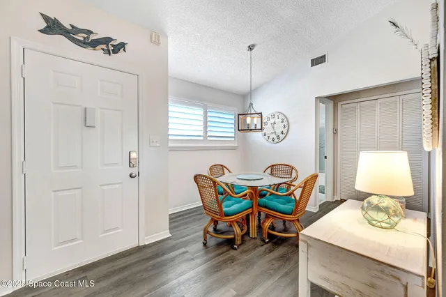 a dining room with furniture and wooden floor