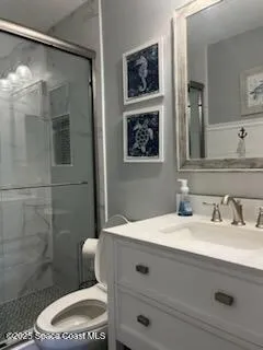a bathroom with a shower toilet and sink