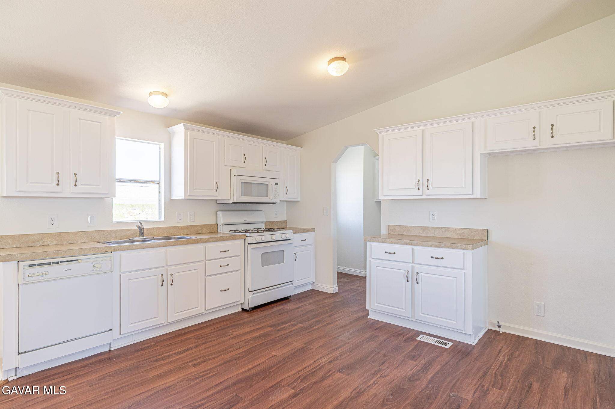 26321 Olanche Street Mojave, CA 93501 - Photo 12 of 40 a kitchen with granite countertop white cabinets and white appliances