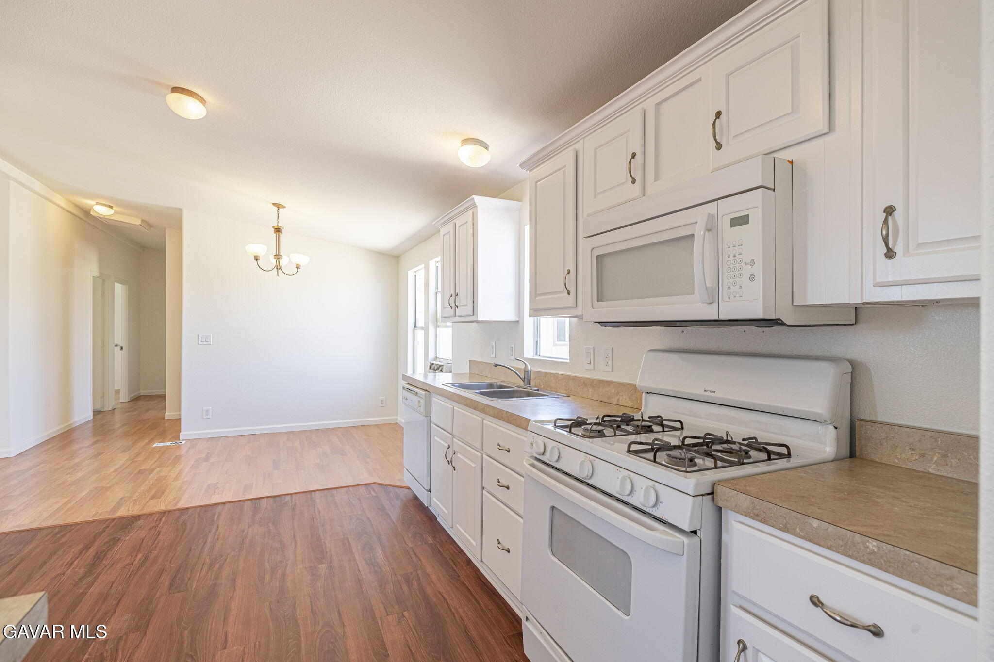 26321 Olanche Street Mojave, CA 93501 - Photo 14 of 40 a kitchen with granite countertop wooden cabinets stove and sink