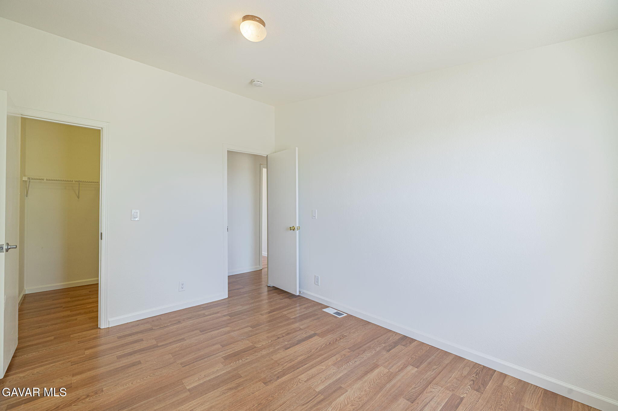 26321 Olanche Street Mojave, CA 93501 - Photo 27 of 40 a view of an empty room with wooden floor and a window