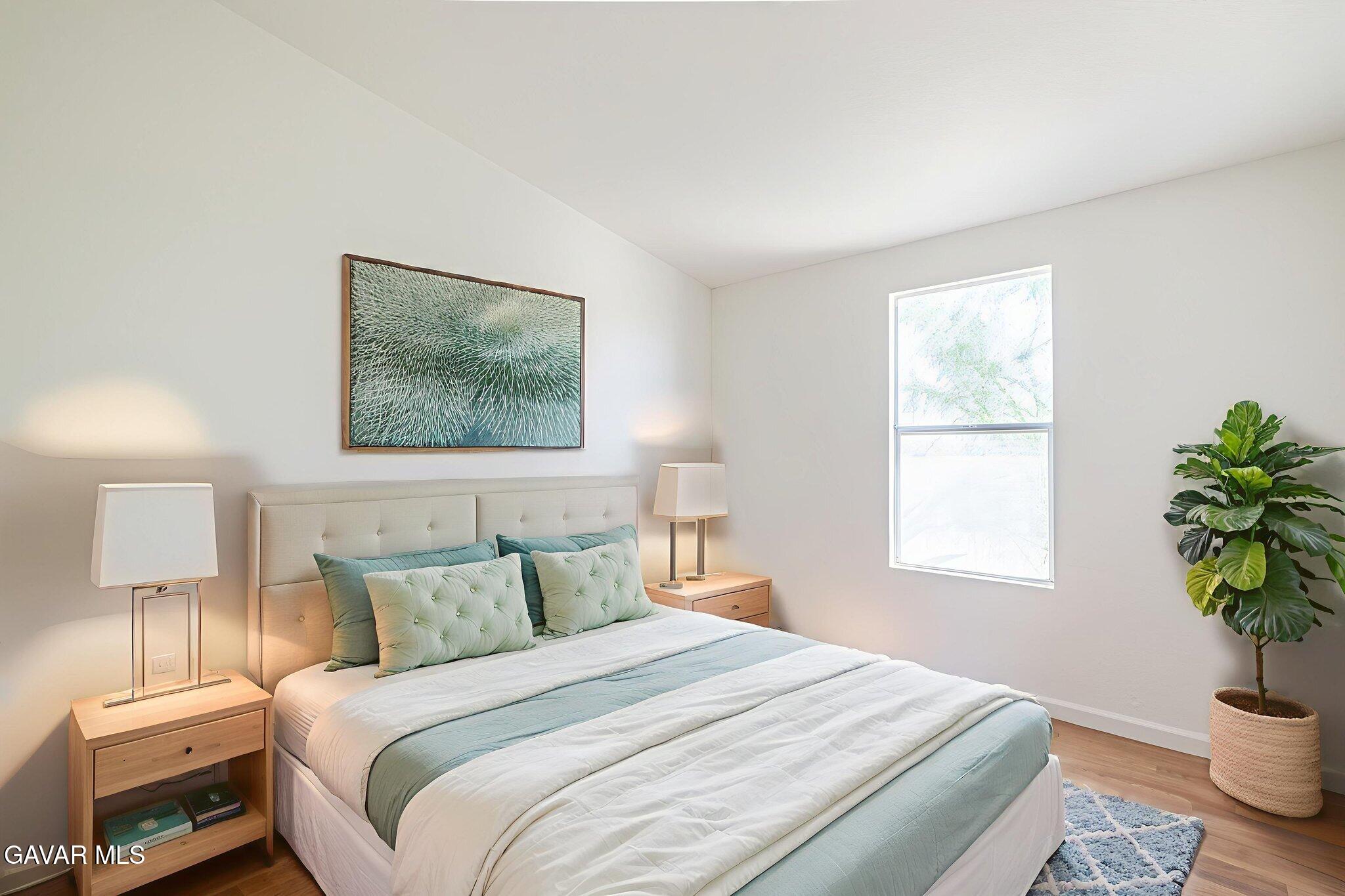 26321 Olanche Street Mojave, CA 93501 - Photo 28 of 40 a bedroom with a bed and a potted plant