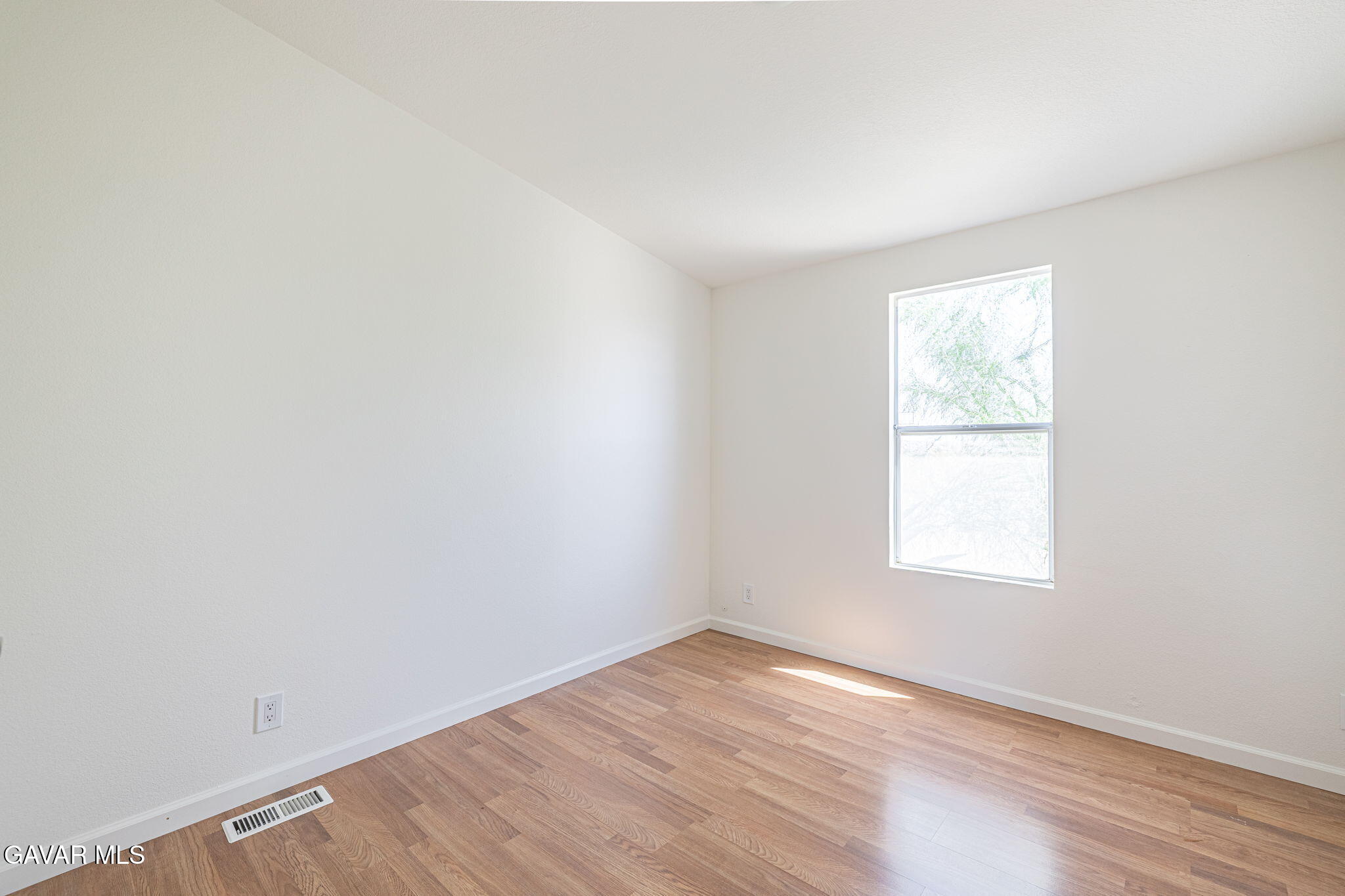 26321 Olanche Street Mojave, CA 93501 - Photo 29 of 40 an empty room with wooden floor and windows