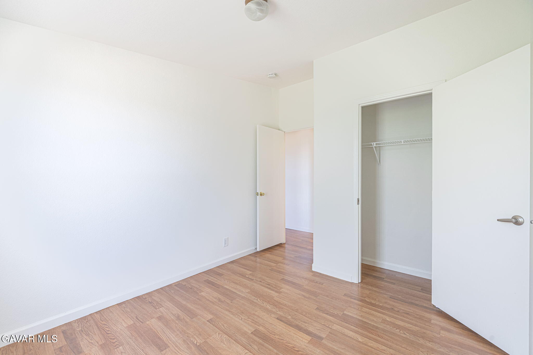 26321 Olanche Street Mojave, CA 93501 - Photo 30 of 40 a view of an empty room with wooden floor and a window