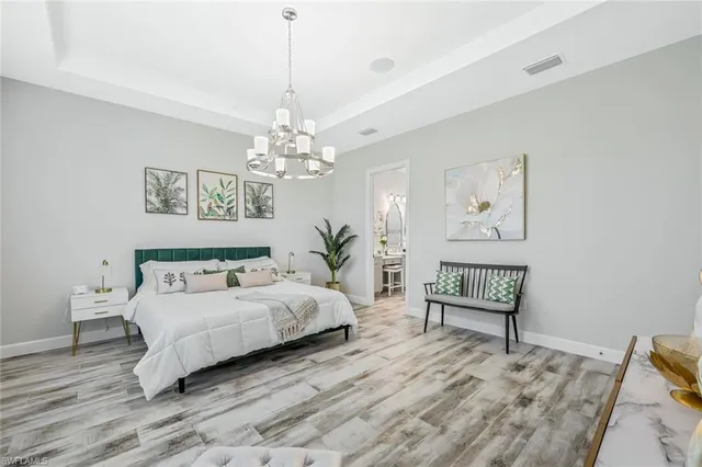 a spacious bedroom with a bed window and couch