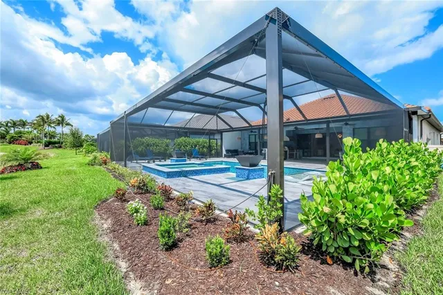 a view of a kitchen with stainless steel appliances kitchen island granite countertop a lot of cabinets and a wooden floor