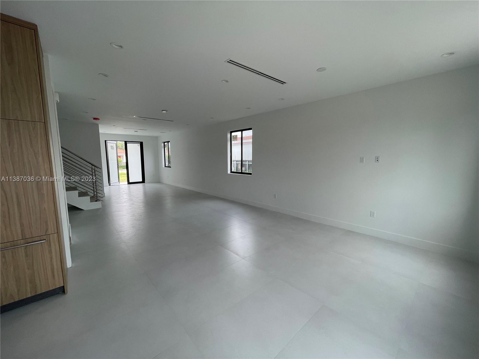 6535 Southwest 26th Street Miami, FL 33155 - Photo 11 of 19 an empty room with staircase and windows
