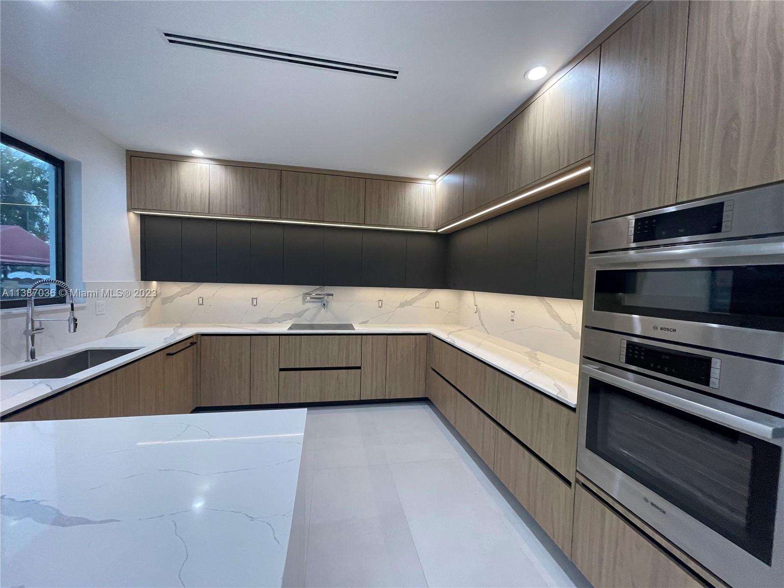 6535 Southwest 26th Street Miami, FL 33155 - Photo 3 of 19 a large kitchen with a large counter top stainless steel appliances and cabinets