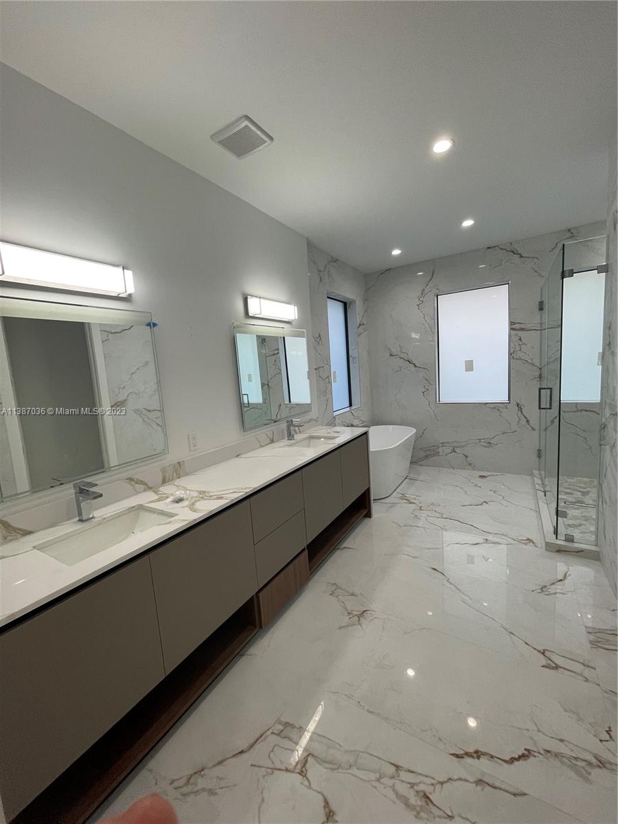 6535 Southwest 26th Street Miami, FL 33155 - Photo 6 of 19 a bathroom with a double vanity sink and a mirror