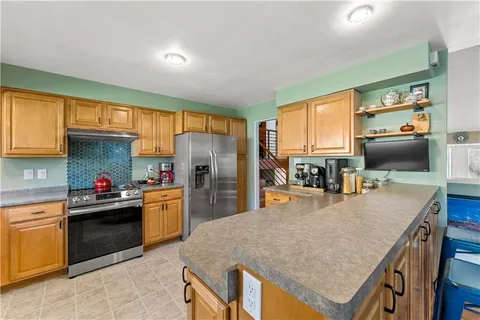 a kitchen with refrigerator and cabinets