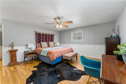a bed room with a bed and a chair