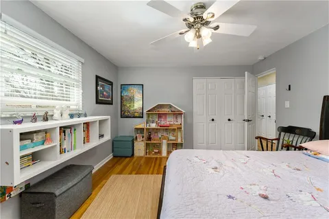 a bedroom with a bed and a large window