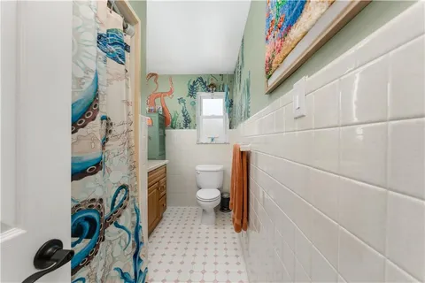 a bathroom with a sink a toilet and a shower curtain