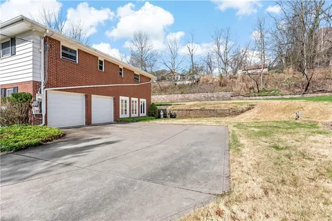 a view of a house with a yard and covered with snow
