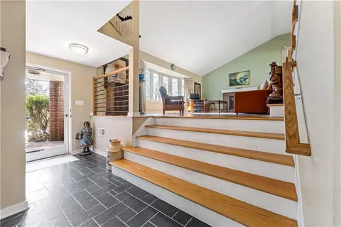 a view of an entryway with wooden floor and windows