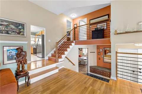 a view of entryway livingroom and hall with wooden floor