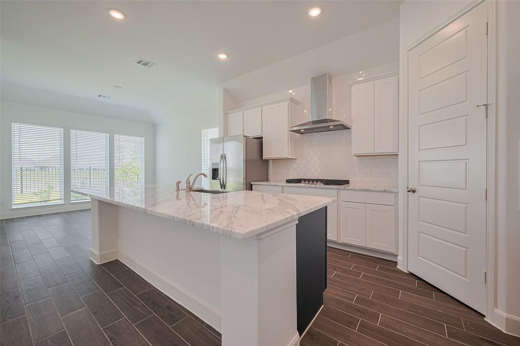 1051 Comal Trail Dayton, TX 77535 - Photo 11 of 49 a kitchen with stainless steel appliances granite countertop a sink and cabinets