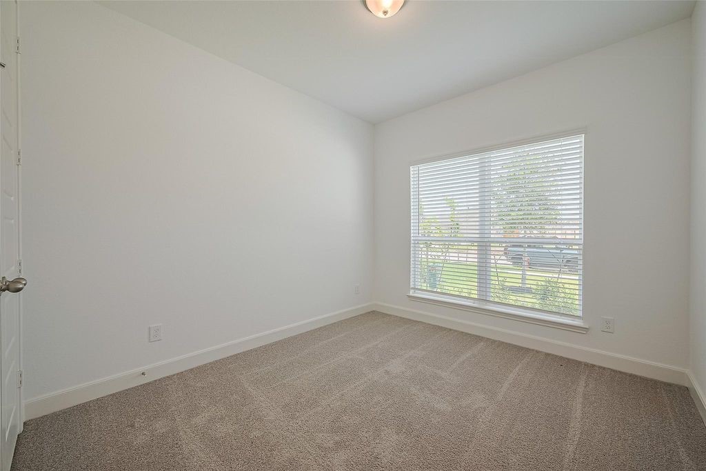 1051 Comal Trail Dayton, TX 77535 - Photo 16 of 49 an empty room with a window