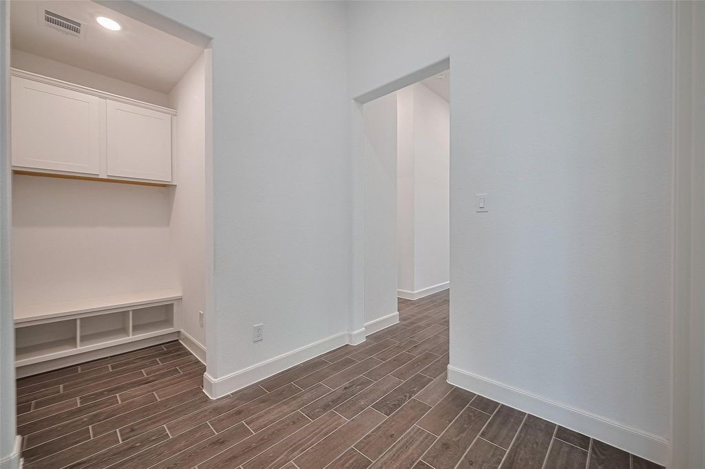 1051 Comal Trail Dayton, TX 77535 - Photo 19 of 49 a view of an empty room with wooden floor