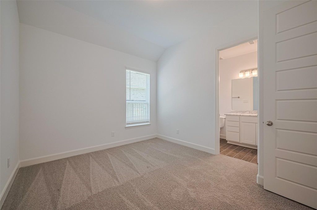 1051 Comal Trail Dayton, TX 77535 - Photo 21 of 49 an empty room with windows and closet