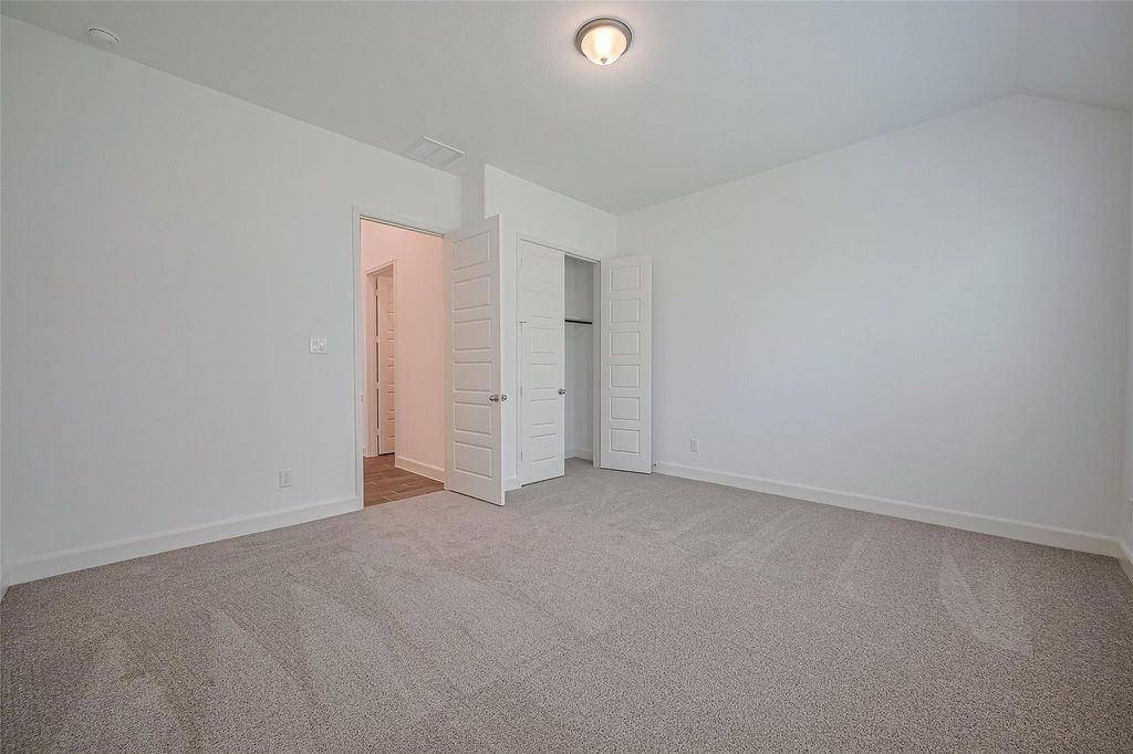 1051 Comal Trail Dayton, TX 77535 - Photo 28 of 49 an empty room with closet area