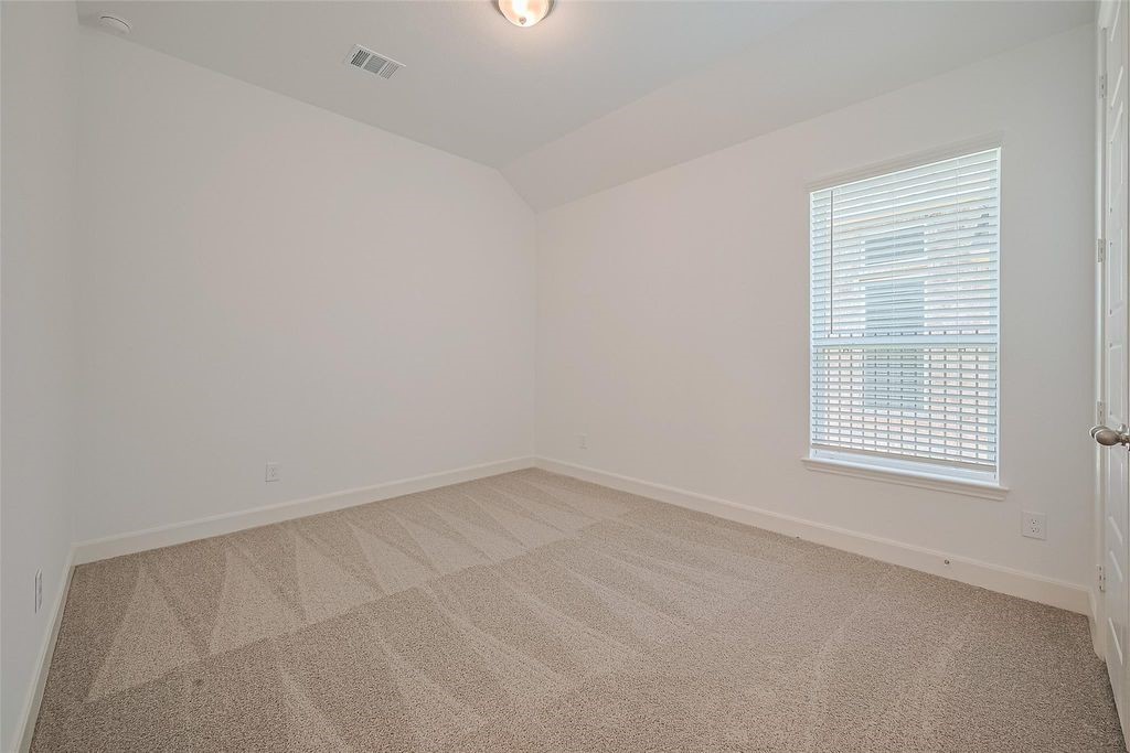 1051 Comal Trail Dayton, TX 77535 - Photo 32 of 49 an empty room with a window