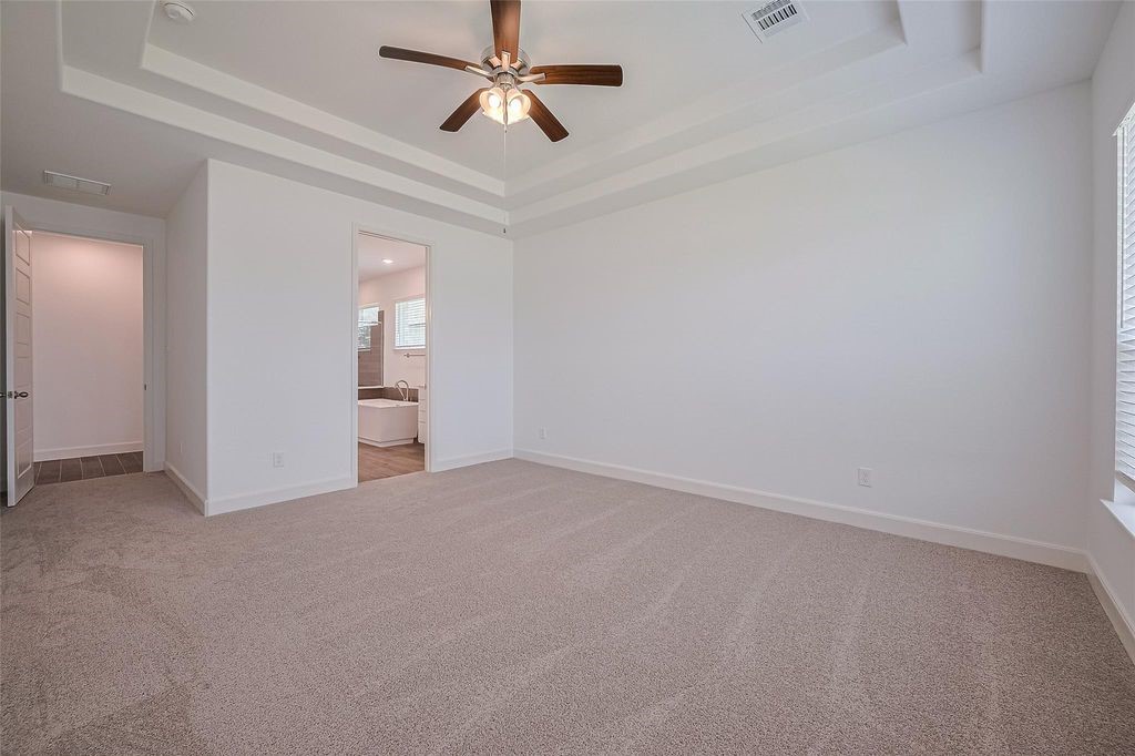 1051 Comal Trail Dayton, TX 77535 - Photo 38 of 49 an empty room with chandelier fan and windows