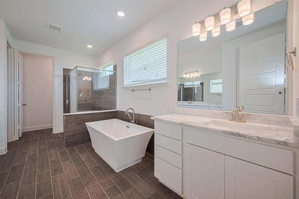 1051 Comal Trail Dayton, TX 77535 - Photo 40 of 49 a bathroom with a sink and a mirror
