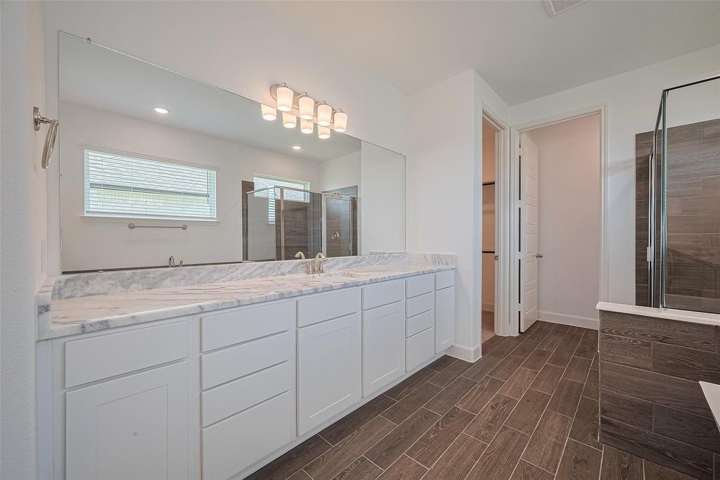 1051 Comal Trail Dayton, TX 77535 - Photo 42 of 49 a bathroom with a double vanity sink and a mirror