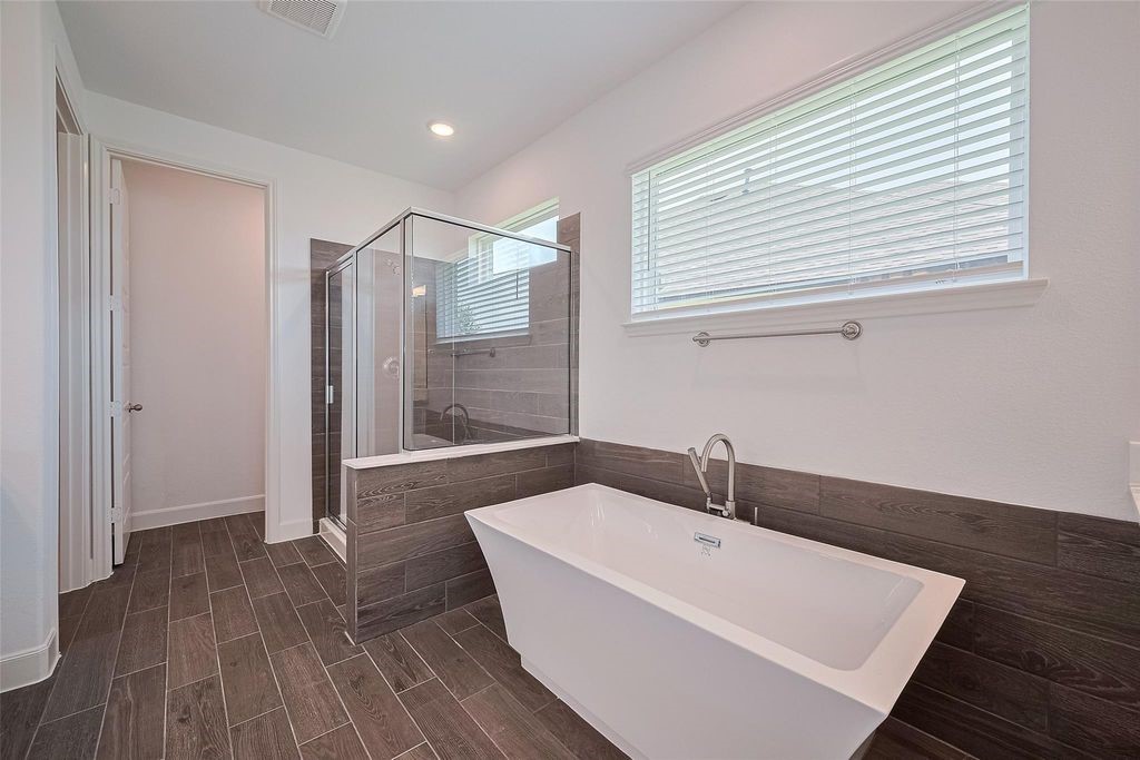 1051 Comal Trail Dayton, TX 77535 - Photo 43 of 49 a bathroom with a sink a mirror and a shower