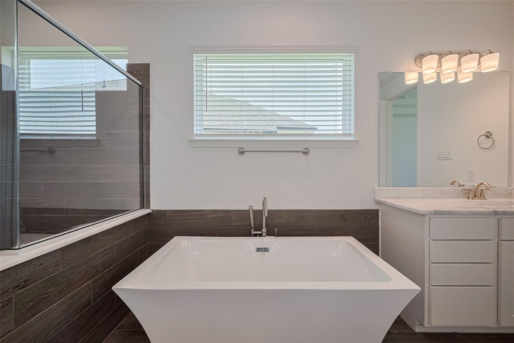 1051 Comal Trail Dayton, TX 77535 - Photo 44 of 49 a bathroom with a bathtub and a sink