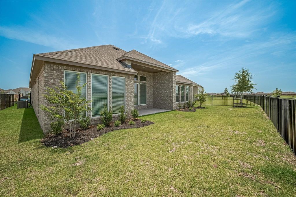 1051 Comal Trail Dayton, TX 77535 - Photo 47 of 49 a front view of a house with garden