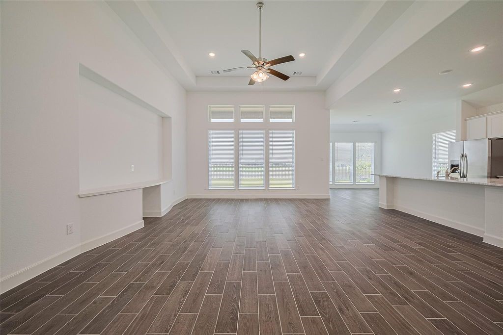 1051 Comal Trail Dayton, TX 77535 - Photo 5 of 49 a view of an empty room with wooden floor and a window