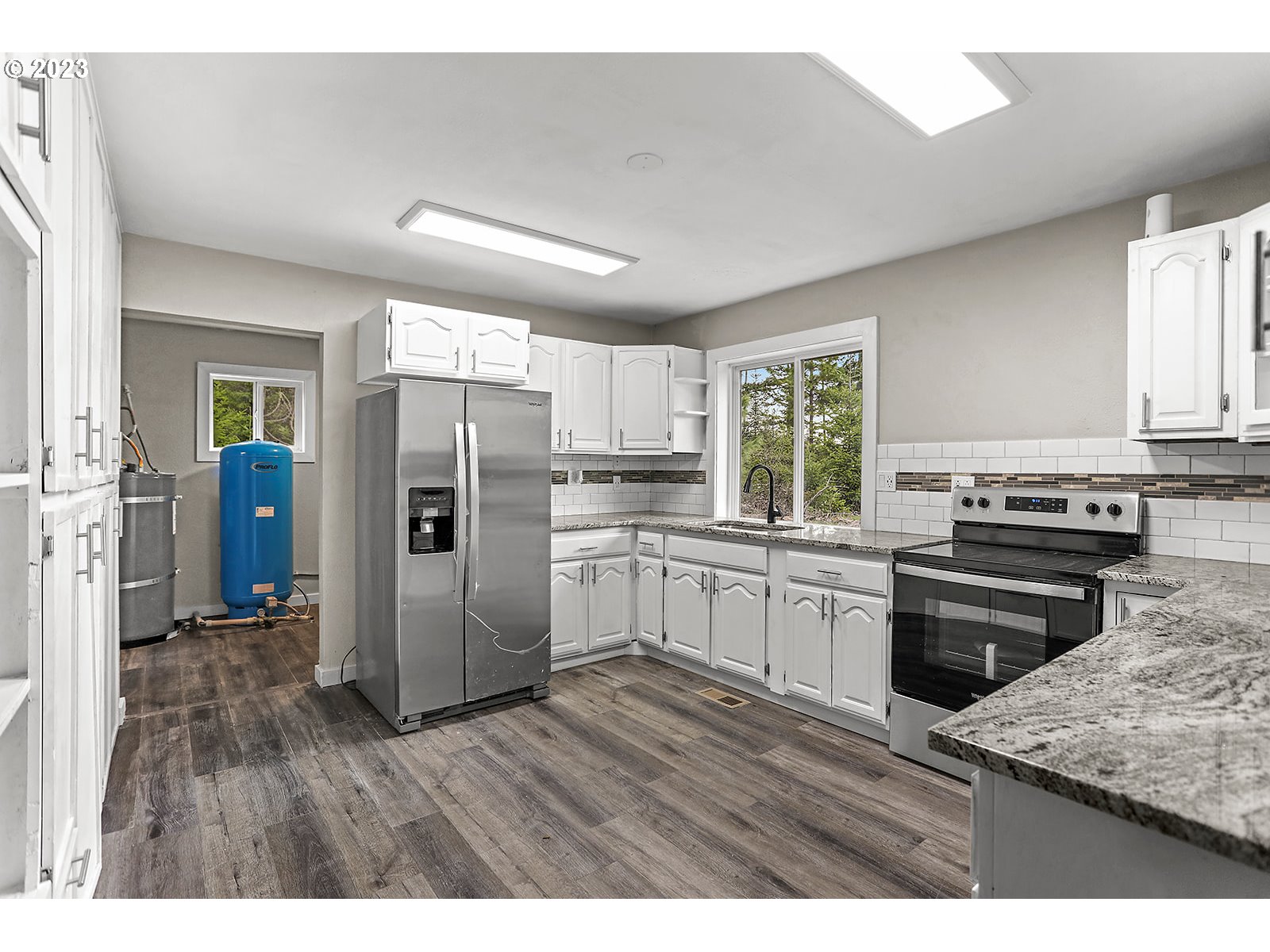 189 Acme Road White Salmon, WA 98672 - Photo 25 of 48 a kitchen with a refrigerator stove and wooden cabinets