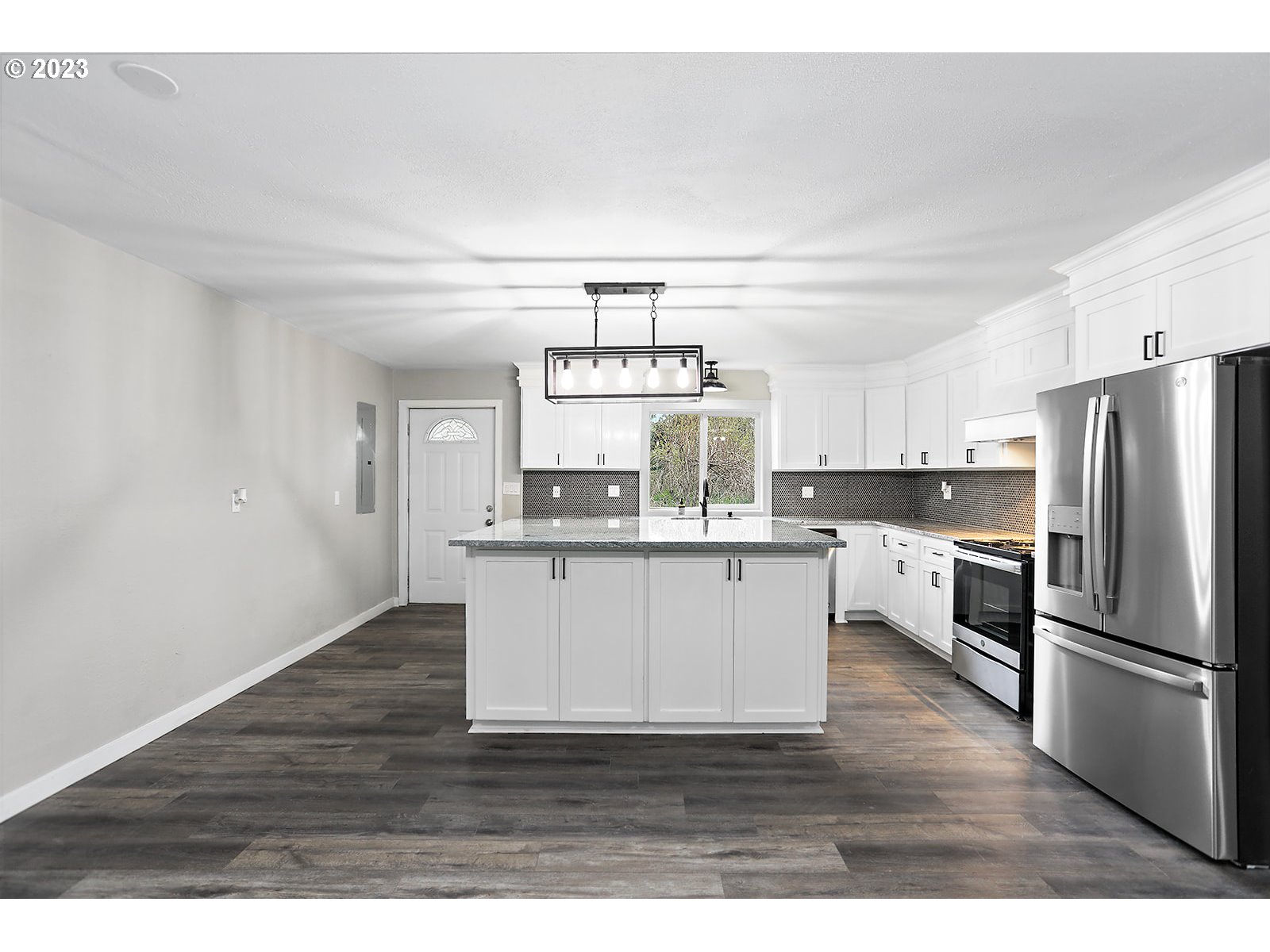 189 Acme Road White Salmon, WA 98672 - Photo 4 of 48 a kitchen with a refrigerator and white cabinets