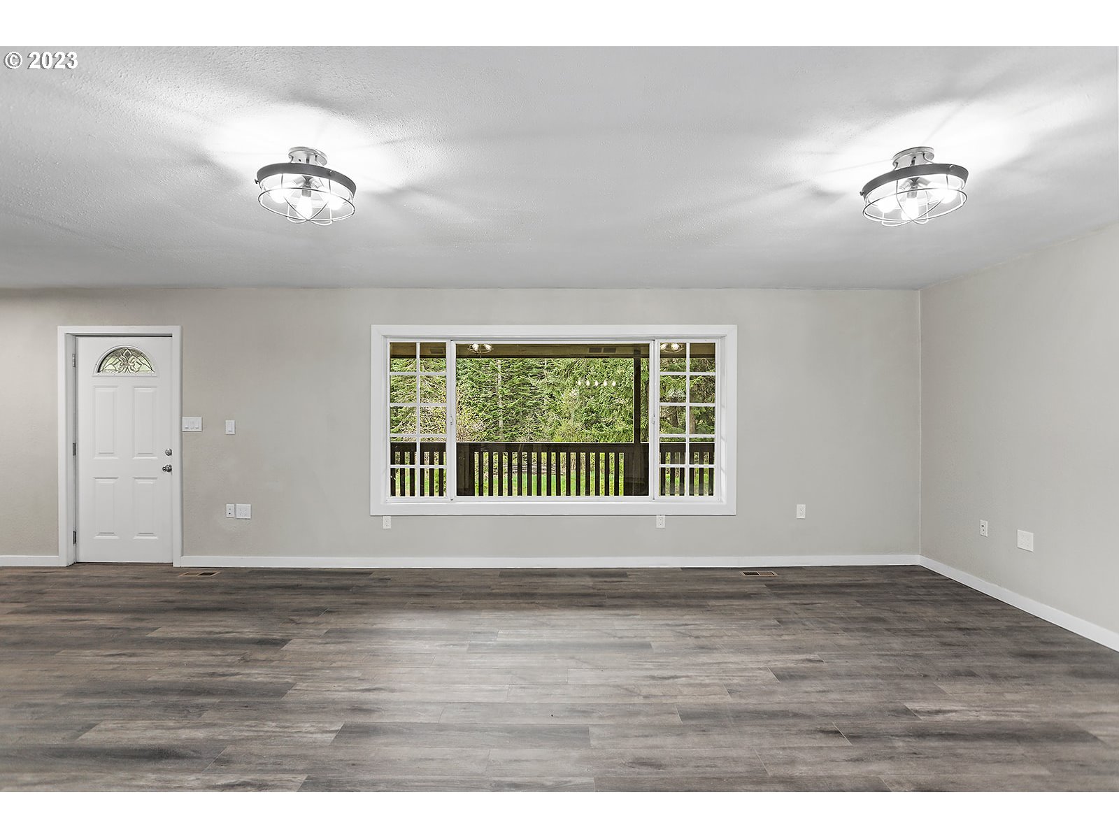 189 Acme Road White Salmon, WA 98672 - Photo 5 of 48 a view of an empty room with wooden floor and a window
