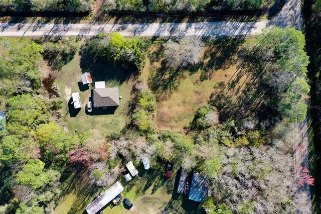 an aerial view of a house with a yard