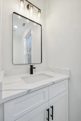 a bathroom with a sink and a mirror