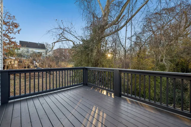 a balcony with wooden floor and fence
