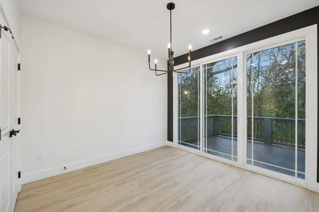 a view of an empty room with glass door