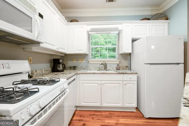 a kitchen with a sink a refrigerator and a stove