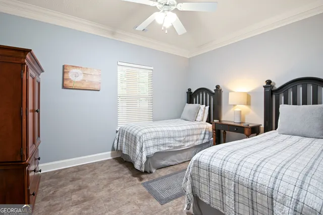 a bedroom with two beds and a window